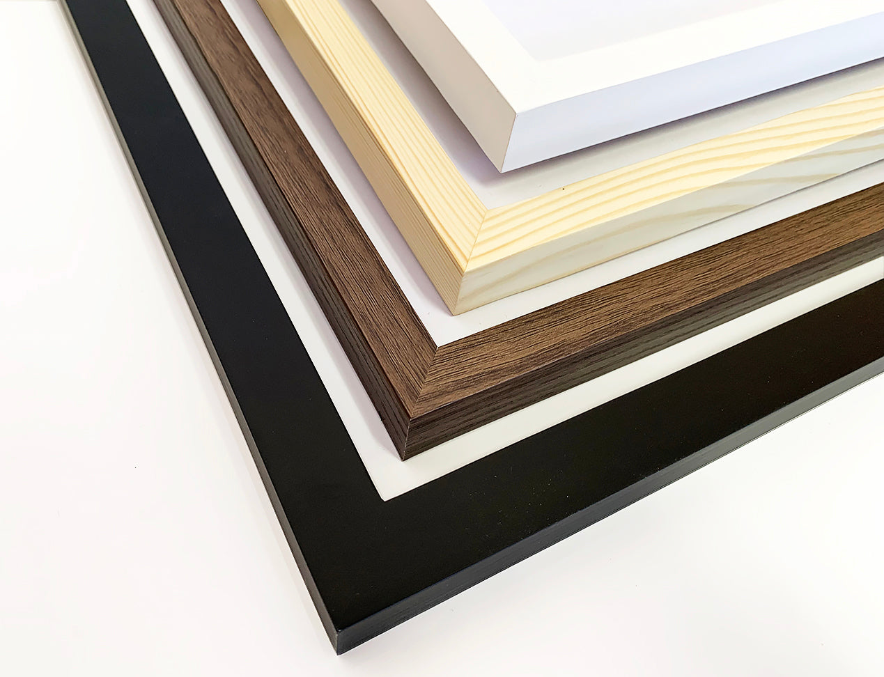 Our Posters with Frame displayed with samples of all the available Frame Colours. Black, white, light brown and dark brown