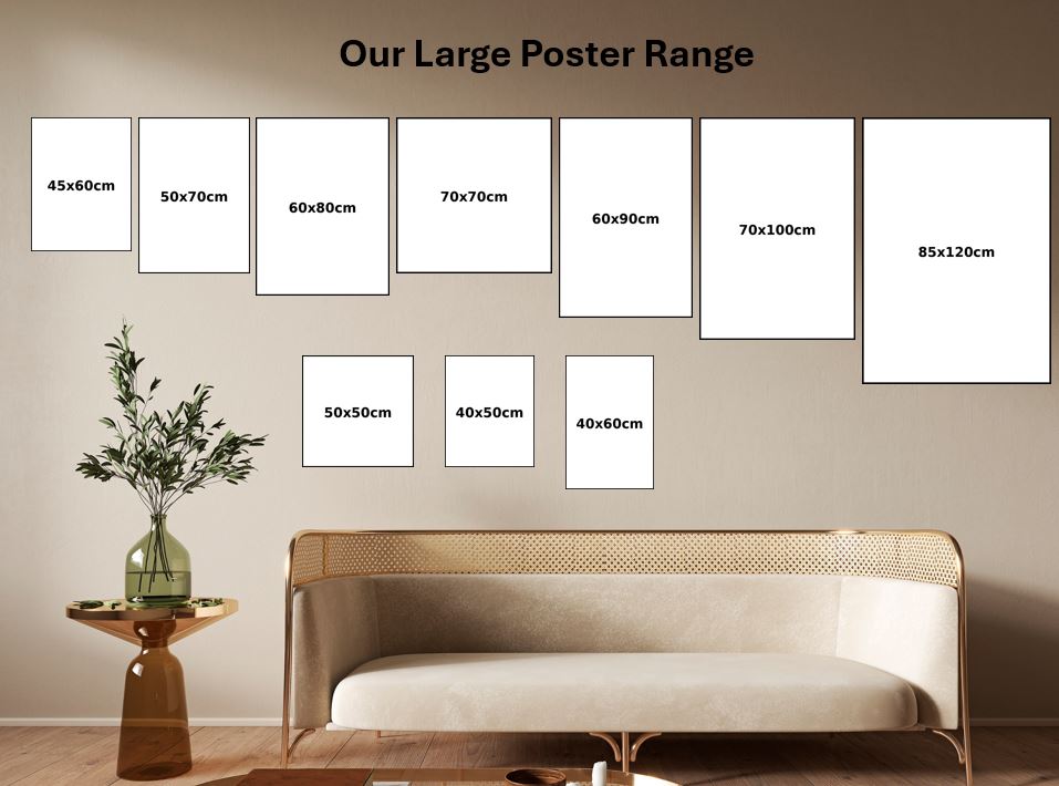 Living room with sofa and plant, displaying large photo poster sizes on a wall.