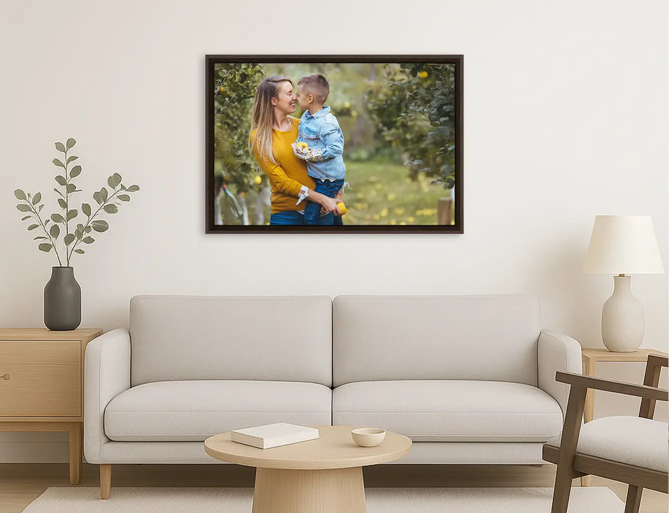 Framed photograph of a couple embracing on a wall above a sofa in a living room.