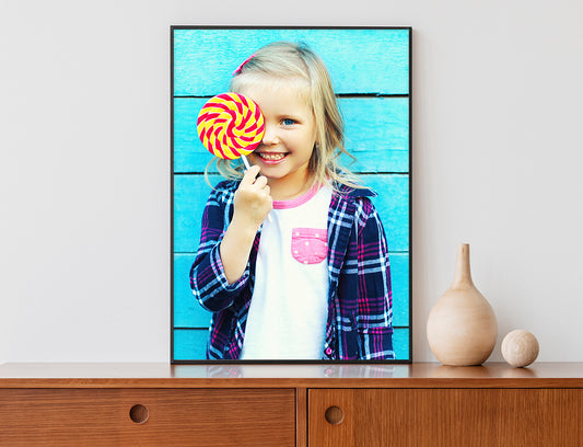 Framed Poster with Kids photo - black frame standing on table