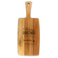 A wooden cheese board with 'Merry Christmas' text and an illustration of a reindeer on it, with a handle on top for gripping.