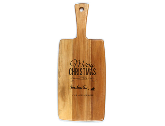 A wooden cheese board with 'Merry Christmas' text and an illustration of a reindeer on it, with a handle on top for gripping.