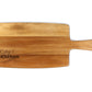 A beige wooden cheese board with 'Kitty's Kitchen' engraved on it, featuring a handle on the right side.