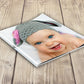 An affordable Classic Soft-Cover Photo Books on a table. Also fits well into pockets.
