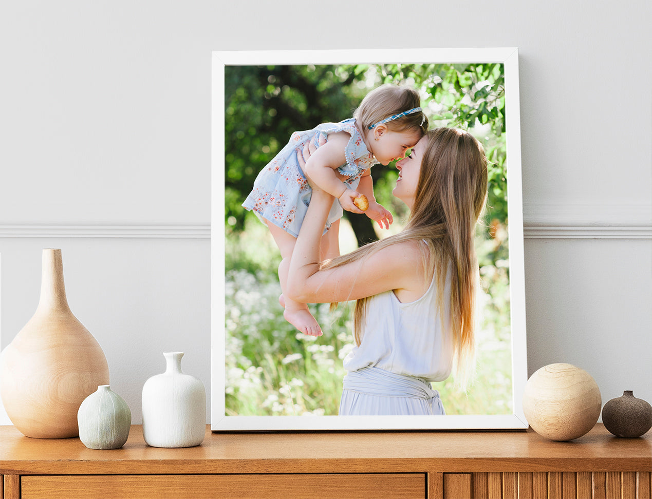 Framed Poster with Photo of women with kid in white frame standing on table