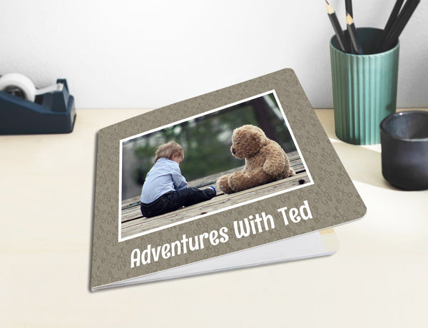 Kids Photo Board Book customised with picture and text, displayed on table.